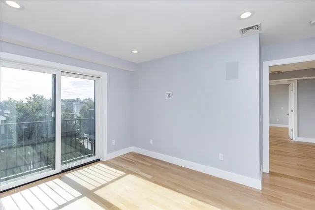 a bedroom with a bed and a hallway