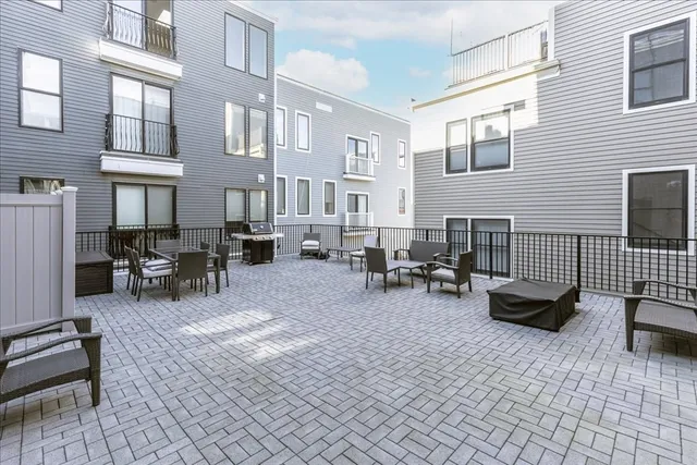 a view of a dinning table and chairs in the patio