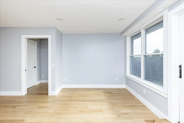 a view of a room with wooden floor and windows