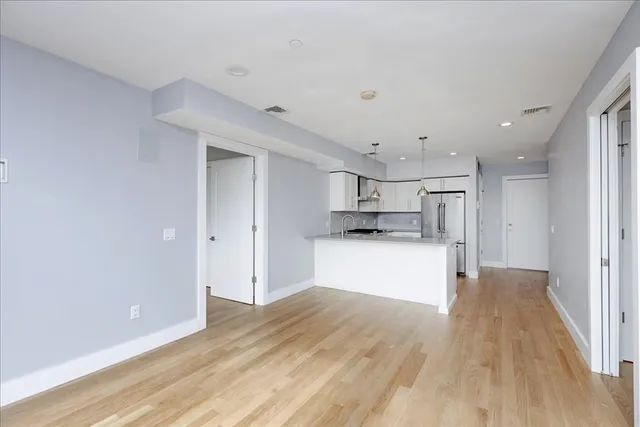 a view of kitchen with wooden floor