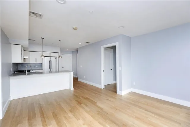 a view of kitchen with cabinets and wooden floor