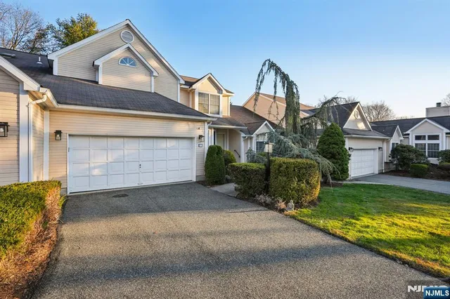 a front view of a house with a yard garage and outdoor seating