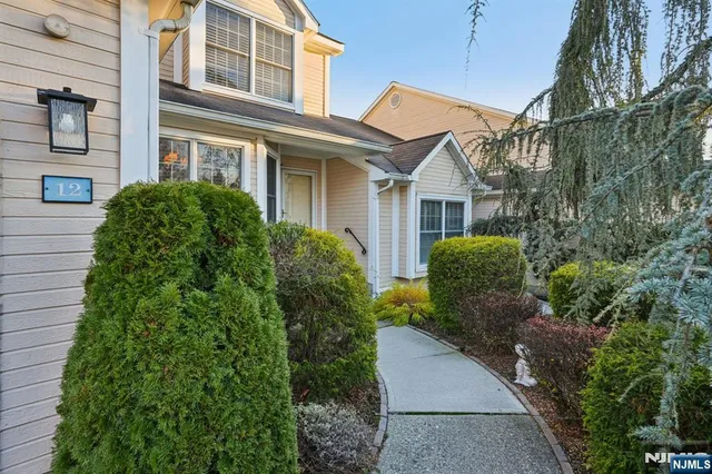 a living room with furniture a rug and a table