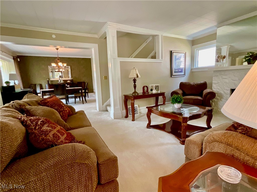 904 Chalker Street Akron, OH 44310 - Photo 6 of 28 Carpeted living room featuring a chandelier and ornamental molding