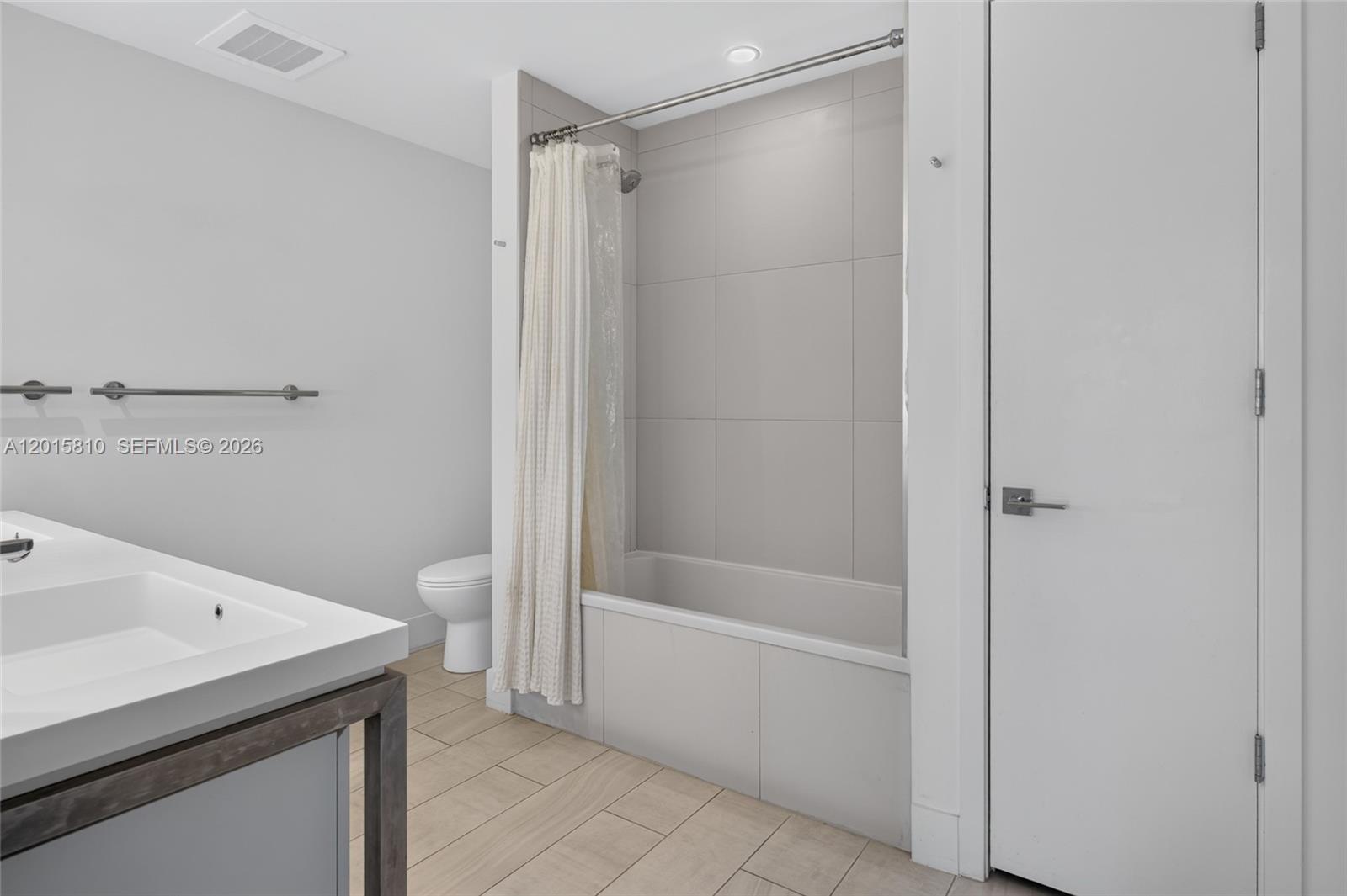 2000 Metropica Way, Unit 1902 Sunrise, FL 33323 - Photo 23 of 40 a bathroom with a bathtub and a shower