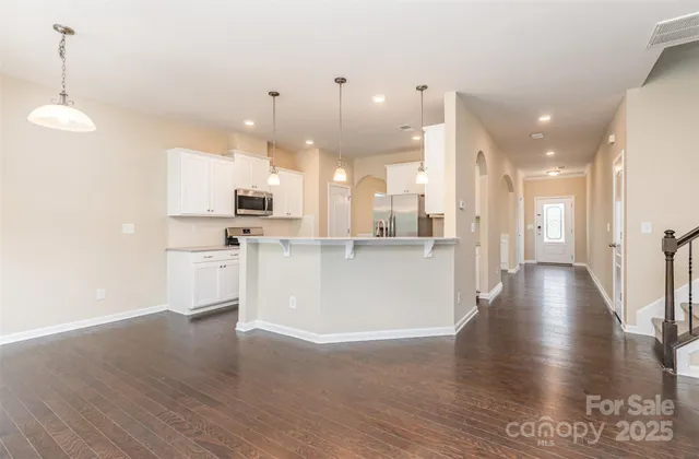 a view of a kitchen with cabinets and wooden floor