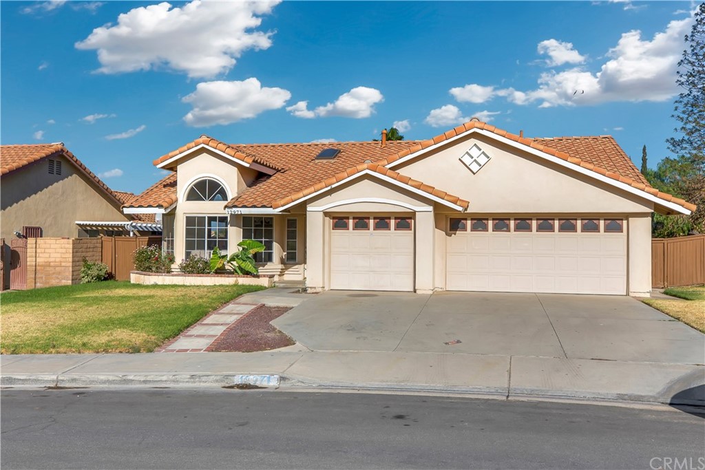 12971 August Circle Riverside, CA 92503 - Photo 1 of 1 a front view of a house with a yard and garage
