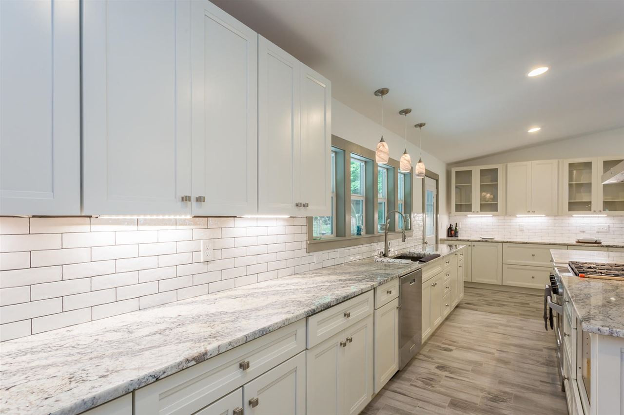 409 Stacy Street Raleigh, NC 27607 - Photo 8 of 25 The classic clean white subway tiles mixed with the nicest slabs of granite we could find just makes this kitchen luxurious yet accessible, picturesque yet functional, "Do Not Touch" yet "Grab a spoon and help me mix it up!" Kitchen