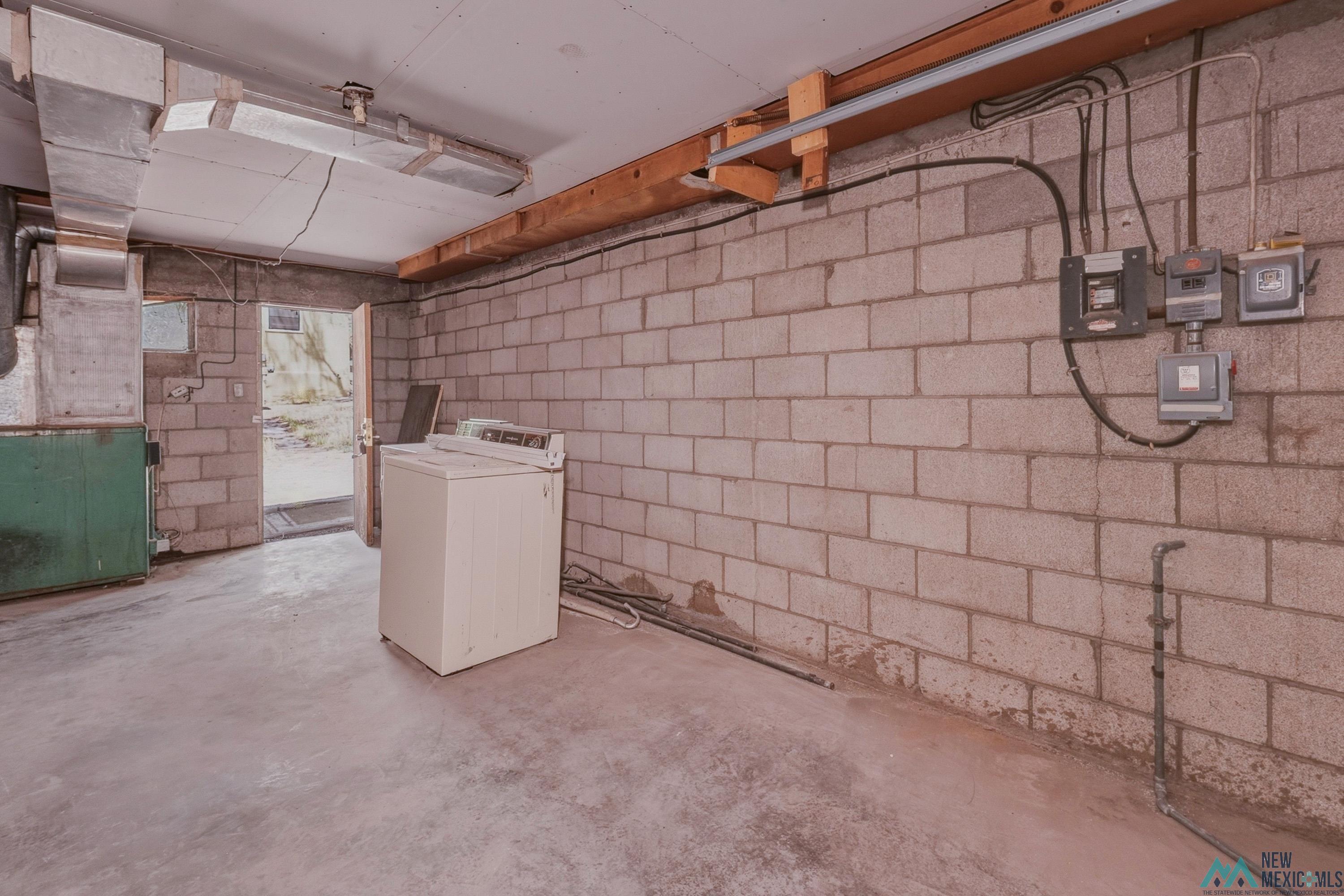 533 South 2nd Street Raton, NM 87740 - Photo 33 of 43 Utility space featuring concrete block walls and a concrete floor