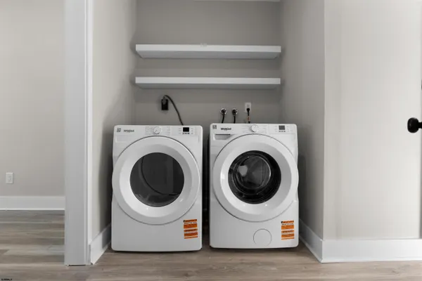 a view of a room that has wooden floor and a window