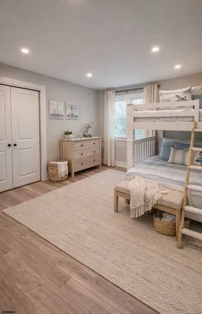 a bathroom with a granite countertop toilet sink and mirror