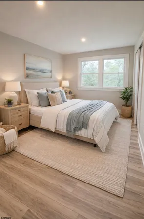 a spacious bedroom with a bed and a large window