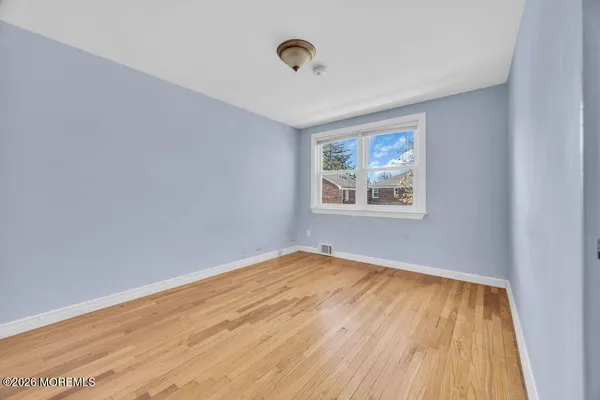a picture of a bench in front of a wall