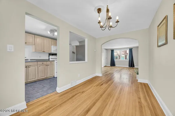 a kitchen with a sink dishwasher a stove and a refrigerator with wooden cabinets