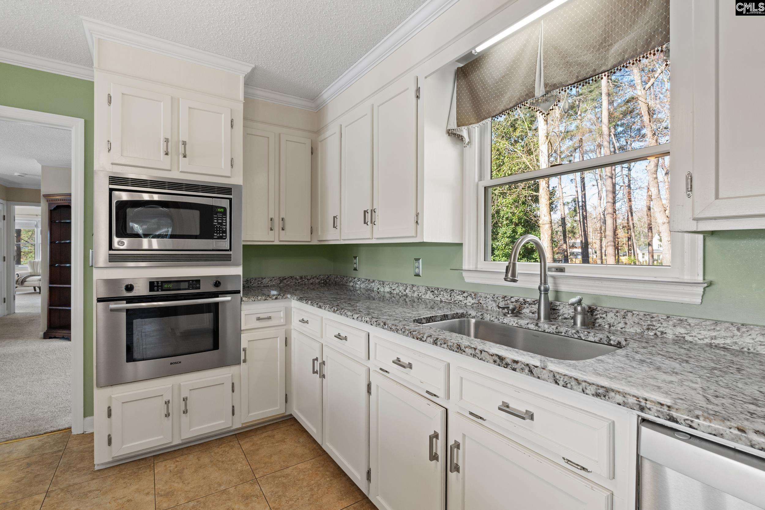 115 Rocky Ridge Road Leesville, SC 29070 - Photo 14 of 51 a kitchen with granite countertop white cabinets white stainless steel appliances and a sink