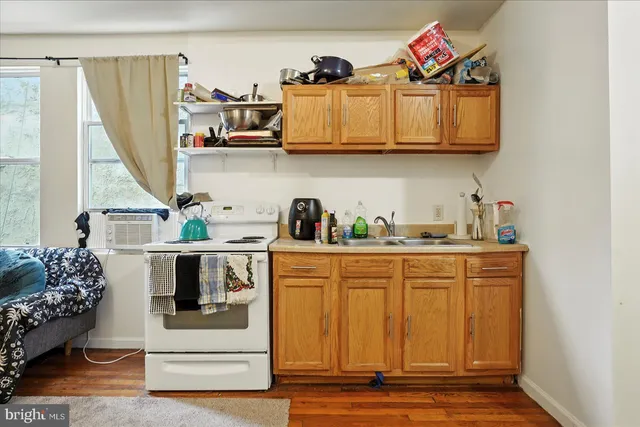 a kitchen with stainless steel appliances granite countertop a white cabinets and a stove