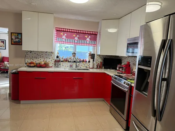 a kitchen with stainless steel appliances a sink stove and refrigerator