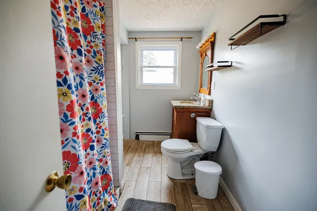 a white toilet sitting next to a shower curtain