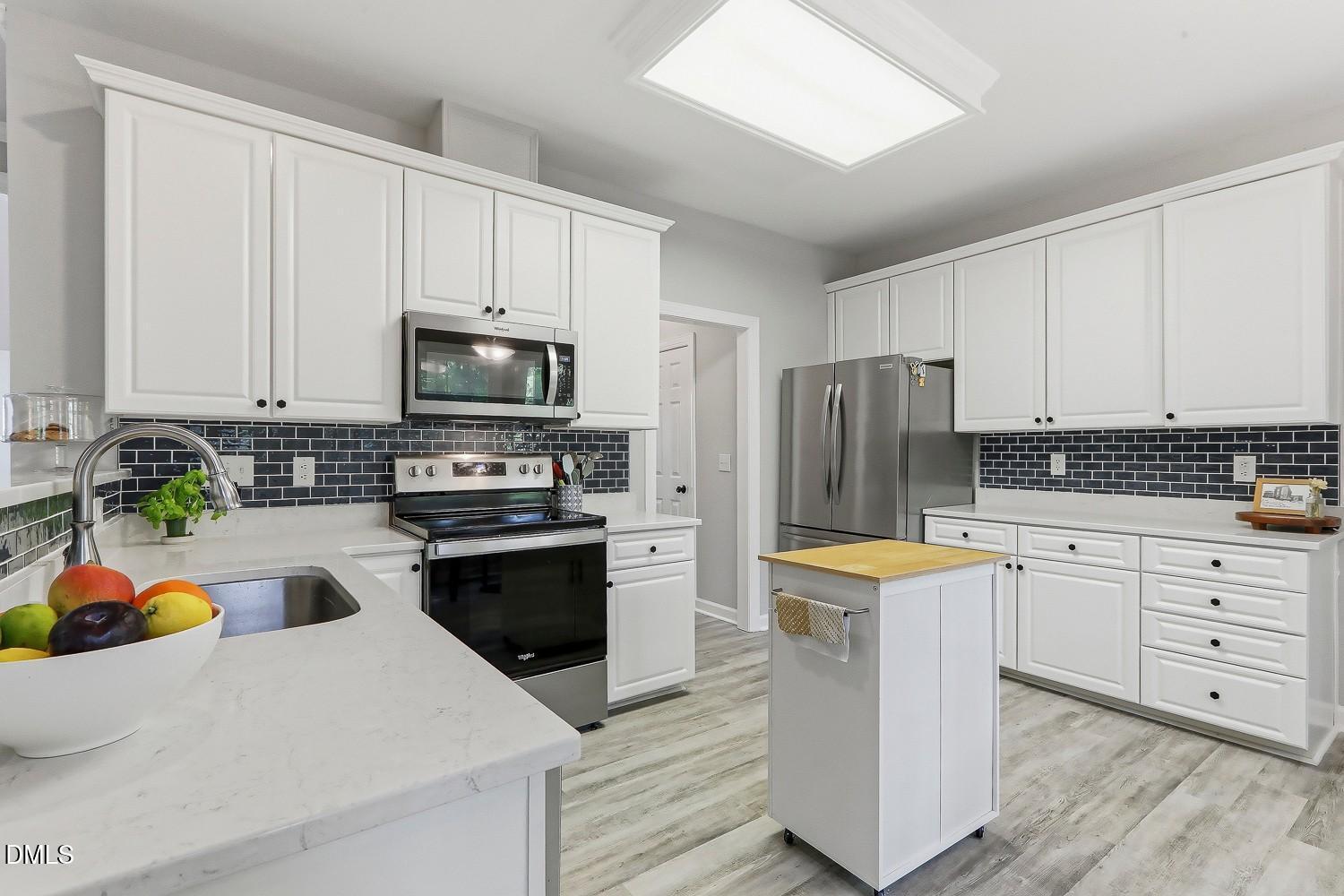 4001 Batiste Road Raleigh, NC 27613 - Photo 16 of 63 a kitchen with stainless steel appliances granite countertop a refrigerator sink and stove