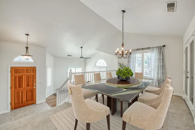 a dining room with furniture window and wooden floor