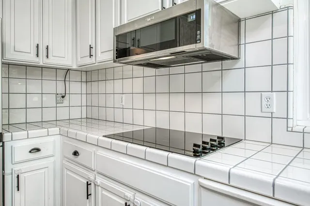 a open dining room with stainless steel appliances kitchen island granite countertop furniture and a window