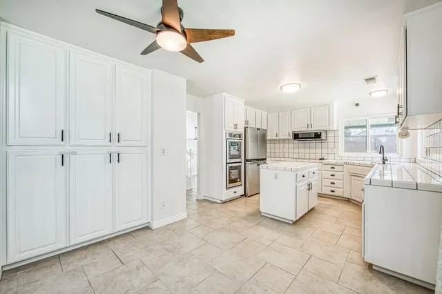a view of livingroom with kitchen view and potted plant