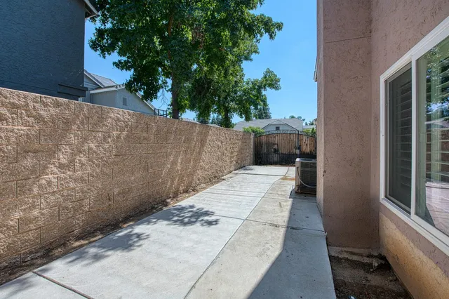 a view of a pathway both side of house