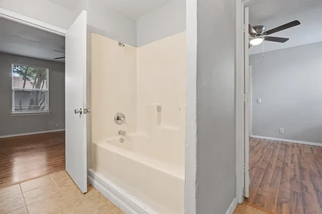 a bathroom with a bathtub and a shower