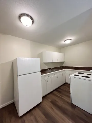 a white refrigerator freezer sitting inside of a kitchen