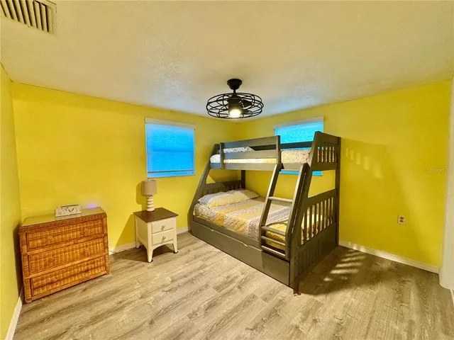 a bedroom with a bed and wooden floor