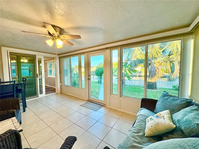 a living room with furniture and large windows