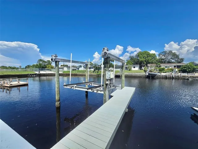 a view of a lake with couches chairs