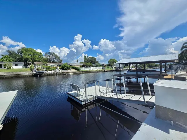 a view of a lake with couches chairs