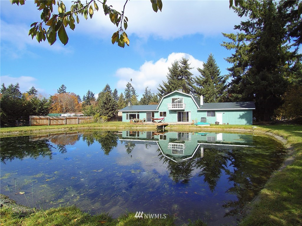 103 Rondale Drive Sequim, WA 98382 - Photo 1 of 35 a view of swimming pool with lawn chairs and iron fence