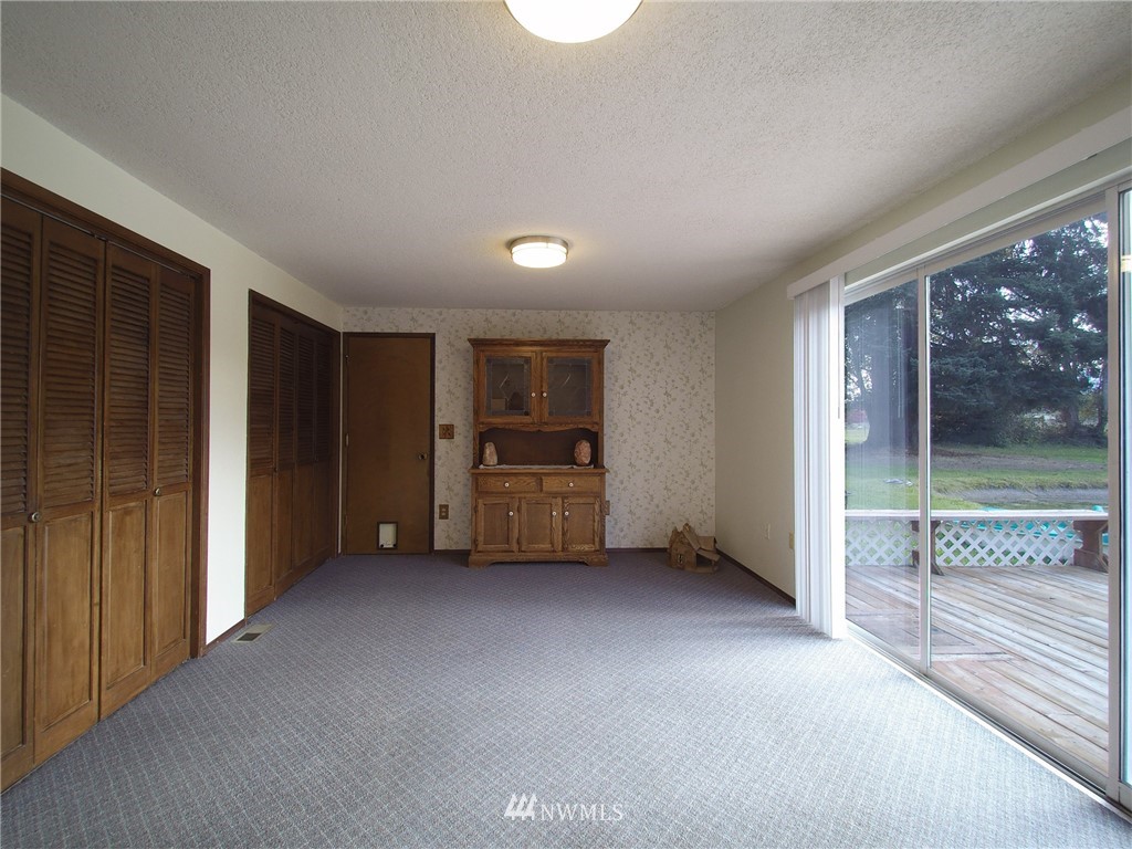 103 Rondale Drive Sequim, WA 98382 - Photo 12 of 35 an empty room with floor to ceiling window and an outdoor view
