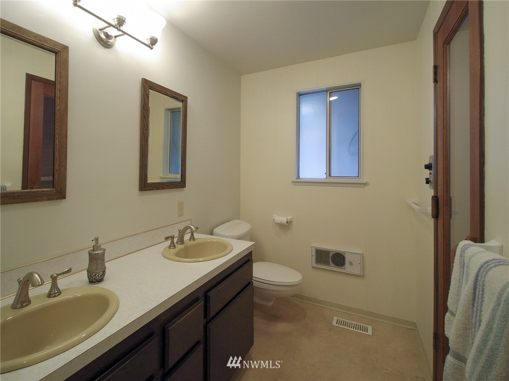 103 Rondale Drive Sequim, WA 98382 - Photo 15 of 35 a bathroom with a sink and a mirror