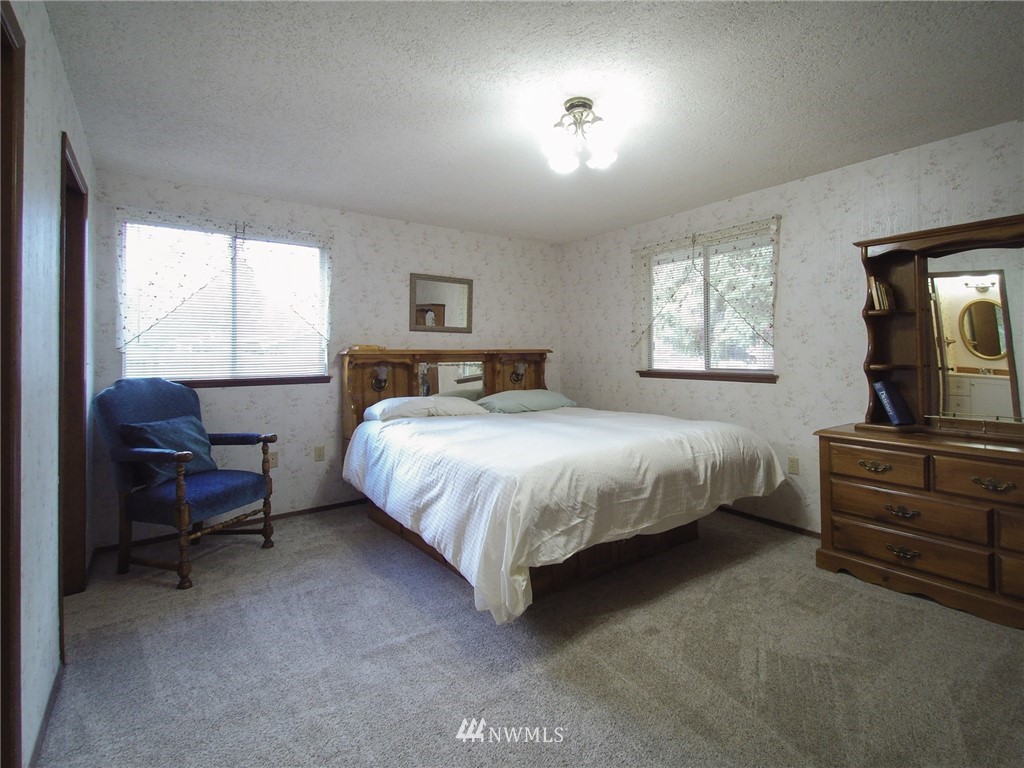 103 Rondale Drive Sequim, WA 98382 - Photo 17 of 35 a bedroom with a bed and a couch