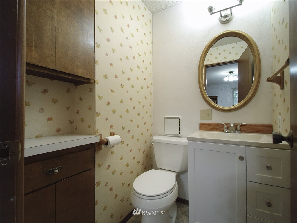 103 Rondale Drive Sequim, WA 98382 - Photo 19 of 35 a bathroom with a toilet sink vanity and mirror
