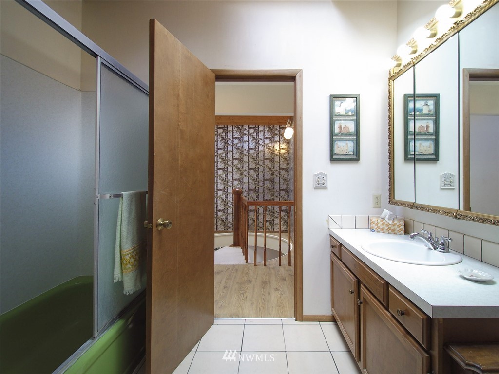 103 Rondale Drive Sequim, WA 98382 - Photo 28 of 35 a bathroom with a sink a mirror and a shower