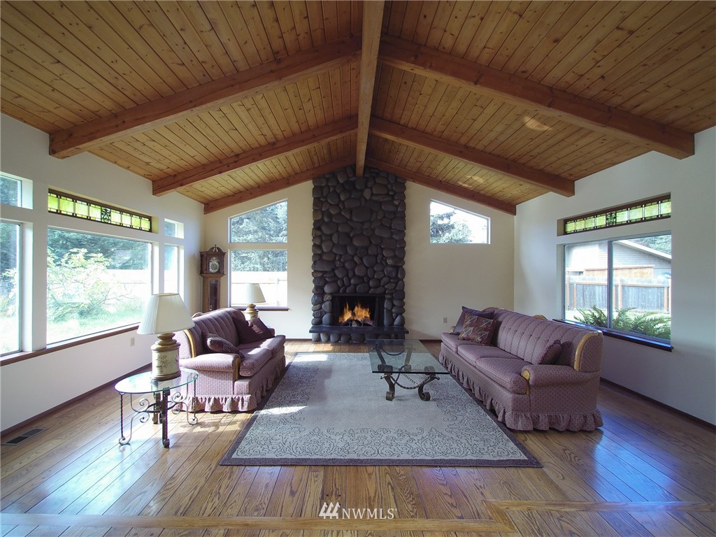 103 Rondale Drive Sequim, WA 98382 - Photo 5 of 35 a living room with furniture a fireplace and a large window
