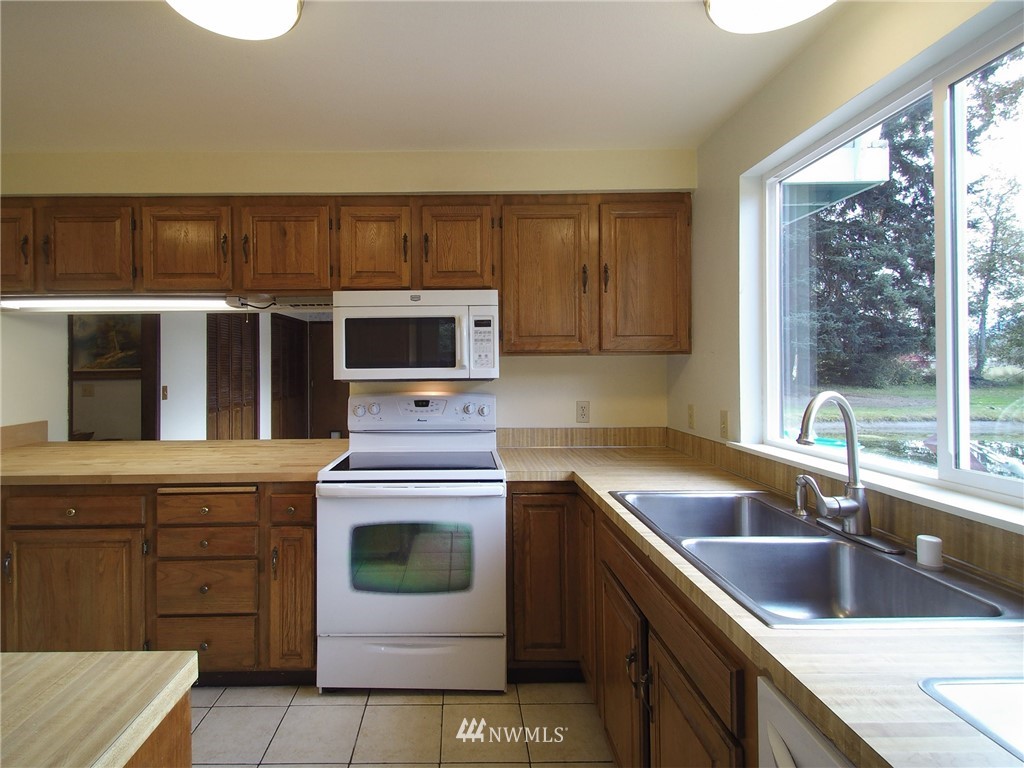 103 Rondale Drive Sequim, WA 98382 - Photo 9 of 35 a kitchen with a stove and a sink