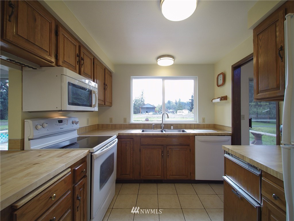 103 Rondale Drive Sequim, WA 98382 - Photo 10 of 35 a kitchen with stainless steel appliances a sink stove and cabinets