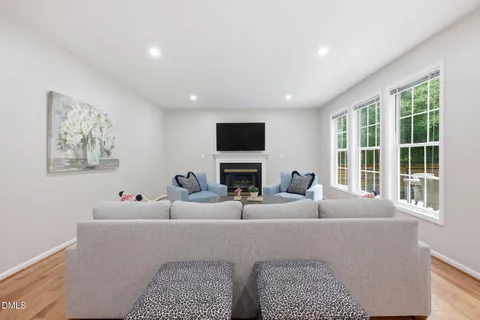 a living room with fireplace furniture and a flat screen tv