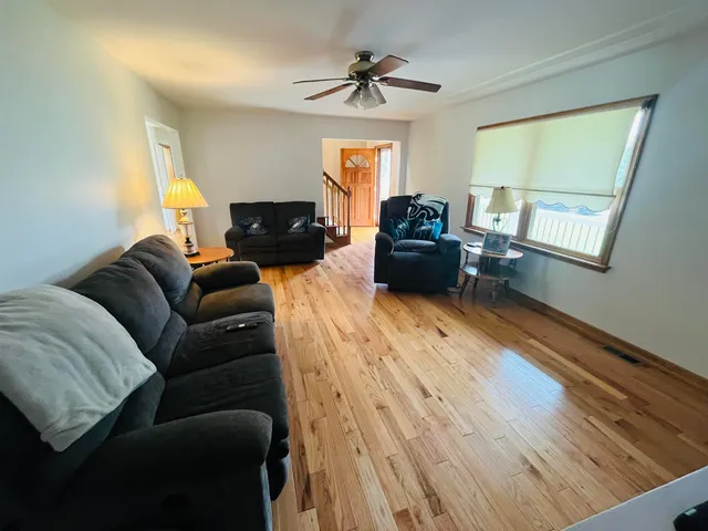a spacious bathroom with a double vanity sink a large mirror and a toilet