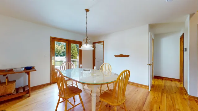a view of a yard in front of a house with plants and large tree