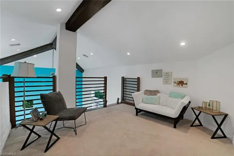 a living room with furniture and a chair