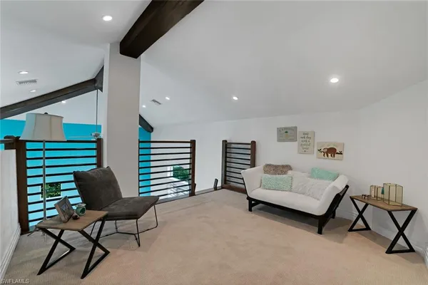 a living room with furniture and a chair