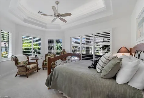 a bedroom with bed and a large window