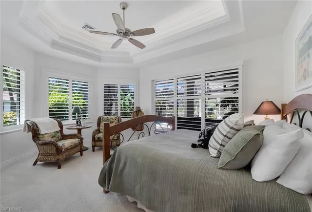 a bedroom with bed and a large window