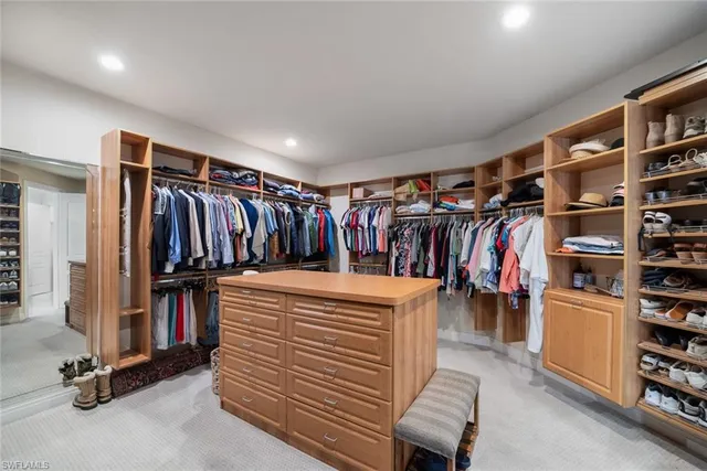 a view of a patio with table and chairs under an umbrella